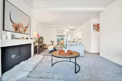 a living room with a table in front of a fireplace at Lux Marina Village with parking in Los Angeles