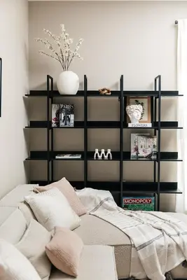 a bedroom with a bed and a shelf with books at Elegant 2BD WeHo Apartment in Los Angeles