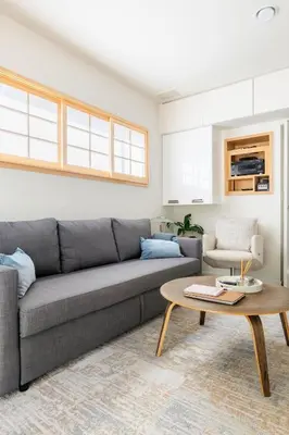 a living room with a gray couch and a table at Garden Oasis by the Sea in Los Angeles