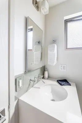 a white bathroom with a sink and a mirror at Garden Oasis by the Sea in Los Angeles