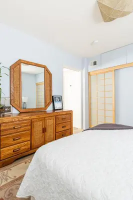 a bedroom with a wooden dresser and a mirror at Garden Oasis by the Sea in Los Angeles