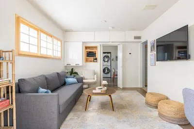 a living room with a gray couch and a table at Garden Oasis by the Sea in Los Angeles