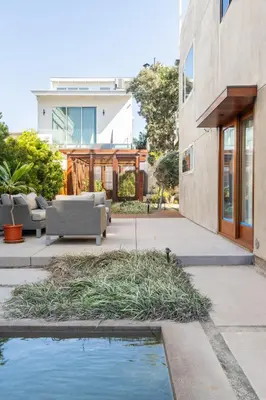 a patio with a pool of water next to a building at Garden Oasis by the Sea in Los Angeles