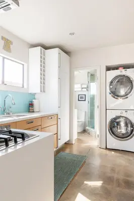 a kitchen with a sink and a washing machine at Garden Oasis by the Sea in Los Angeles