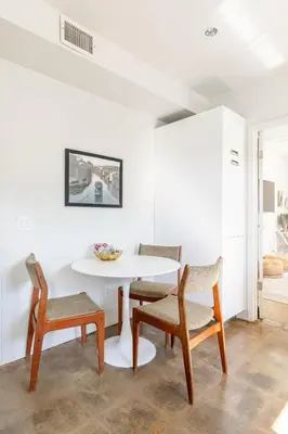 a white dining room with a table and chairs at Garden Oasis by the Sea in Los Angeles