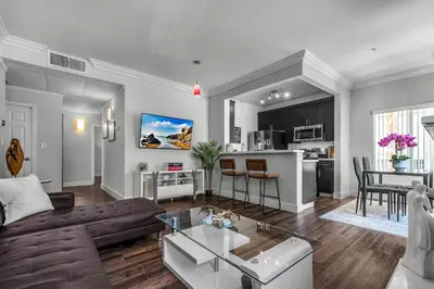 a living room with a couch and a table at Heart of La, Walk to everything!! in Los Angeles