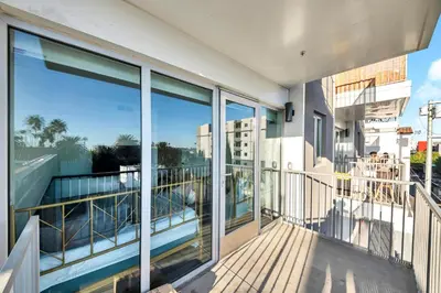 a balcony of a building with glass windows at fusion hollywood in Los Angeles