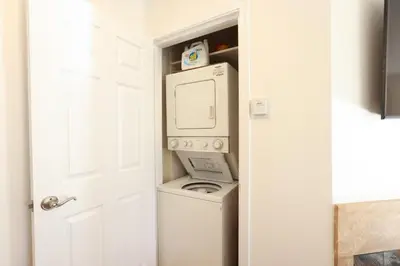 a laundry room with a washer and dryer next to a door at SM ocean view in Los Angeles