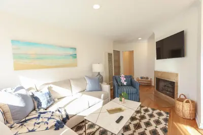 a living room with a white couch and a fireplace at SM ocean view in Los Angeles