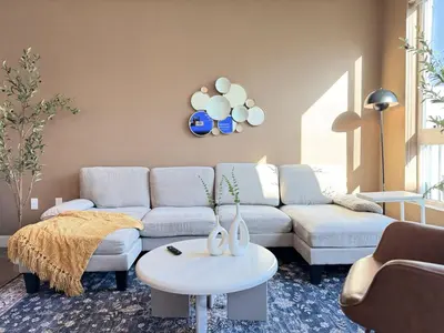 a living room with a couch and a table at New Oasis Near Disneyland Pool Gym Free Parking in Santa Ana