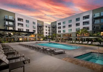 a swimming pool with chairs and a building at New Oasis Near Disneyland Pool Gym Free Parking in Santa Ana