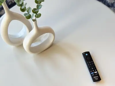 two white vases and a remote control on a table at New Oasis Near Disneyland Pool Gym Free Parking in Santa Ana