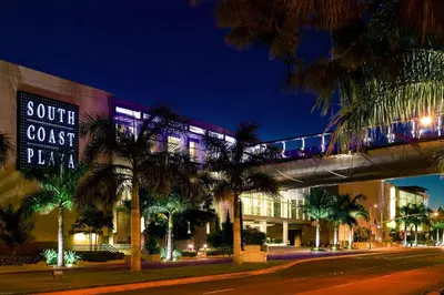 a train on a bridge over a street at night at Charming 2BR Retreat Pool Gym 10min to Disneyland in Santa Ana