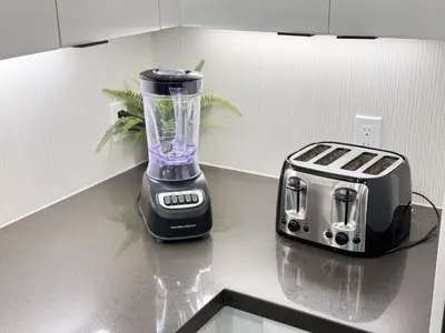 a blender sitting on a counter next to a toaster at Charming 2BR Retreat Pool Gym 10min to Disneyland in Santa Ana