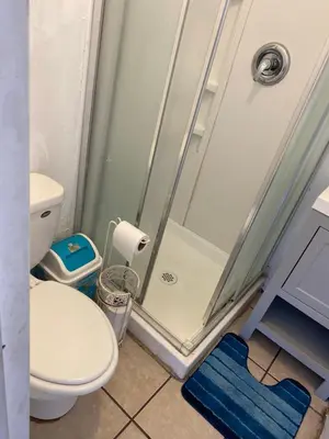 a bathroom with a toilet and a glass shower at Affordable Rooms in RV Trailer in Los Angeles