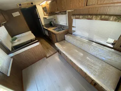 an overhead view of an rv with a bench in a kitchen at Affordable Rooms in RV Trailer in Los Angeles