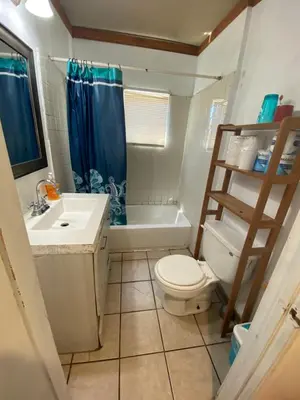 a bathroom with a toilet and a sink and a shower at Affordable Rooms in RV Trailer in Los Angeles