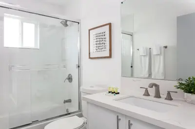 a bathroom with a shower and a toilet and a sink at Prestige 5BR Townhome Near LA Hot Spots in Los Angeles