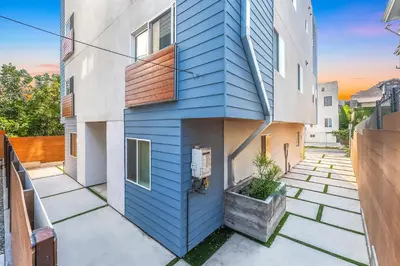 a house with blue siding on the side of it at Central 4BR Townhome Modern Perks in Los Angeles