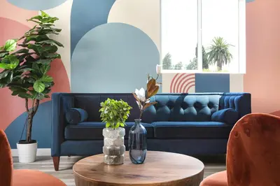 a living room with a blue couch and a table at Central 4BR Townhome Modern Perks in Los Angeles