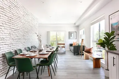 a dining room with a table and green chairs at Spacious 4BR LA Getaway with Parking and Fast Wi-Fi in Los Angeles