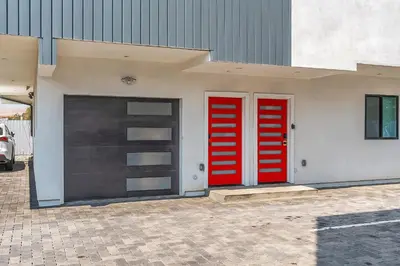 two red doors on the side of a building at Spacious 4BR LA Getaway with Parking and Fast Wi-Fi in Los Angeles