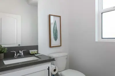 a bathroom with a toilet and a sink at 3BR Urban Retreat with Modern Amenities in Los Angeles
