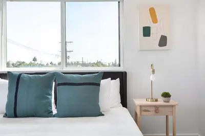 a bedroom with a bed with a pillow and a window at Spacious 5BR Townhouse with Free Parking Included in Los Angeles