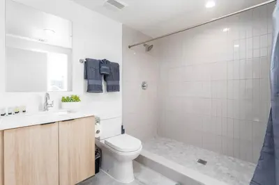 a bathroom with a toilet and a sink and a shower at Sunset Views from Private Rooftop in Luxe Townhome in Los Angeles