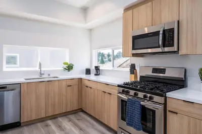 a kitchen with a stove and a microwave at Sunset Views from Private Rooftop in Luxe Townhome in Los Angeles