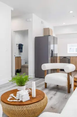 a living room with a table and a chair at Sunset Views from Private Rooftop in Luxe Townhome in Los Angeles