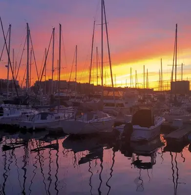 a group of boats docked in a marina at sunset at Marina del Rey 1BR apt Ocean Walk, Pool, Hot Tub, Gym, BBQ, Lagoon, Sunset Views in Los Angeles