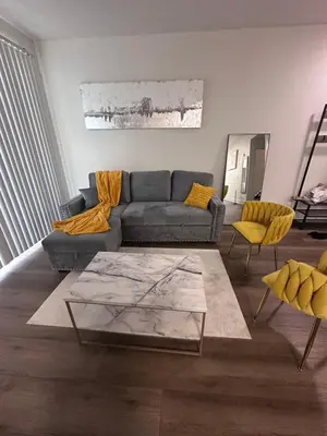 a living room with a couch and a table at Marina del Rey 1BR apt Ocean Walk, Pool, Hot Tub, Gym, BBQ, Lagoon, Sunset Views in Los Angeles