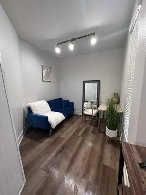 a living room with a blue couch and a mirror at Marina del Rey 1BR apt Ocean Walk, Pool, Hot Tub, Gym, BBQ, Lagoon, Sunset Views in Los Angeles