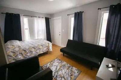 a living room with a bed and a couch at Cozy room in East Holywood, 7 min from holllywood, 15 from downtown, 20 to hollywood sing in Los Angeles