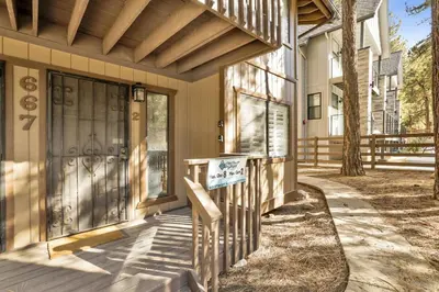 a front door of a house with a sign on it at Slope Side Getaway at Big Bear - Central Duplex Retreat Chalet in Big Bear Lake