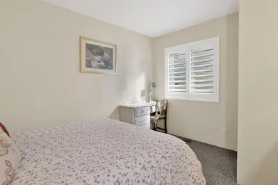 a white bedroom with a bed and a window at Slope Side Getaway at Big Bear - Central Duplex Retreat Chalet in Big Bear Lake