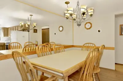 a kitchen and dining room with a table and chairs at Slope Side Getaway at Big Bear - Central Duplex Retreat Chalet in Big Bear Lake