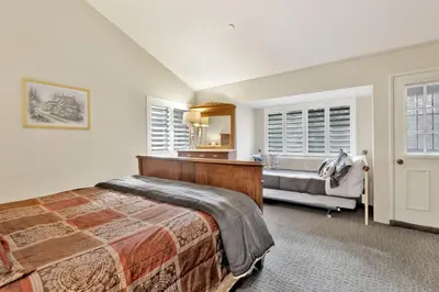a bedroom with a bed and a couch at Slope Side Getaway at Big Bear - Central Duplex Retreat Chalet in Big Bear Lake