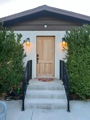 a house with a wooden door and a staircase at Hanna's Corner in Canoga Park