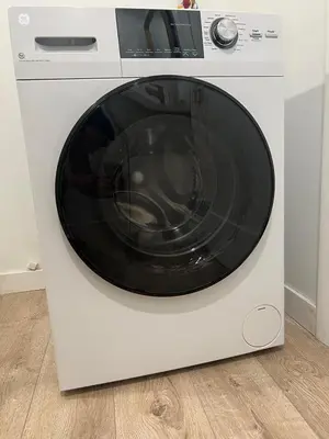 a white dryer with a microwave on top of it at Hanna's Corner in Canoga Park