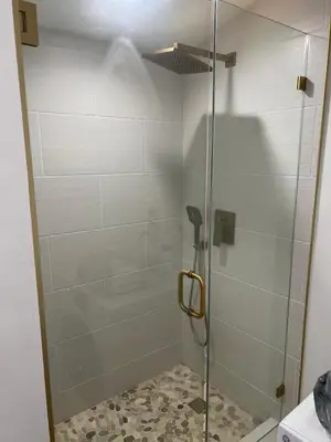a shower with a glass door in a bathroom at Hanna's Corner in Canoga Park