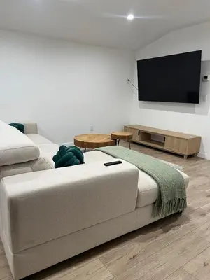 a living room with a couch and a flat screen tv at Hanna's Corner in Canoga Park