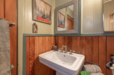 a bathroom with a sink and a mirror at Dream Lake Cabin Spa, EV Charger, Gated, by lake! in Big Bear Lake