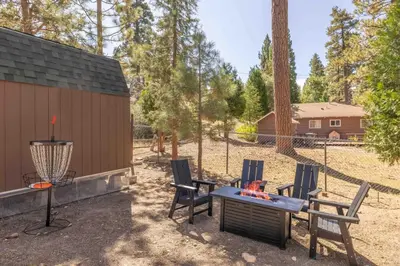 a patio with chairs and a table and a grill at Dream Lake Cabin Spa, EV Charger, Gated, by lake! in Big Bear Lake