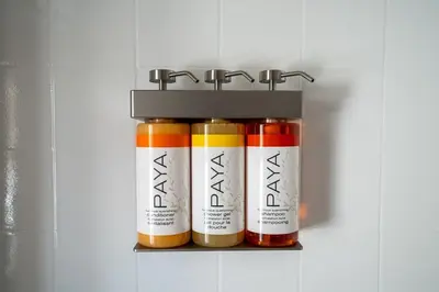 a shelf with four bottles of paint in a refrigerator at Modern Bachelor in Hollywood in Los Angeles