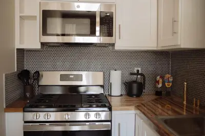 a kitchen with a stove and a microwave at The Hollywood Sign Lookout in Los Angeles