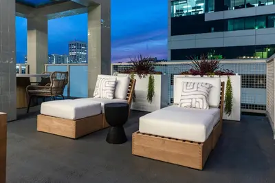two beds on a balcony with a view of a city at WEHO Place By Sunset Plaza in Los Angeles