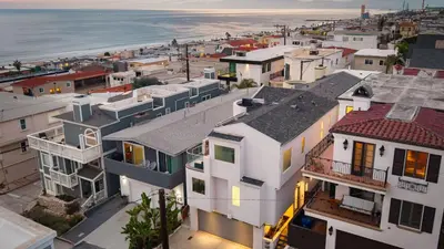 an aerial view of a city with houses and the ocean at Walk to Manhattan Beach Pier Ocean Views Balcony Peloton Casa Del Mar by AvantStay in Manhattan Beach