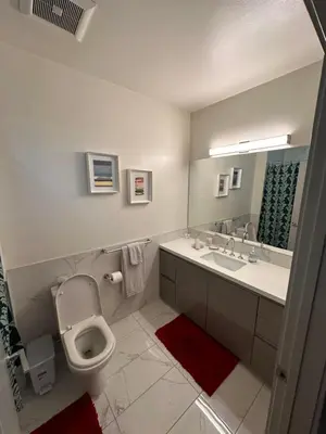 a bathroom with a toilet and a sink and a mirror at Luxury 2BR Apt with balcony!! in Los Angeles